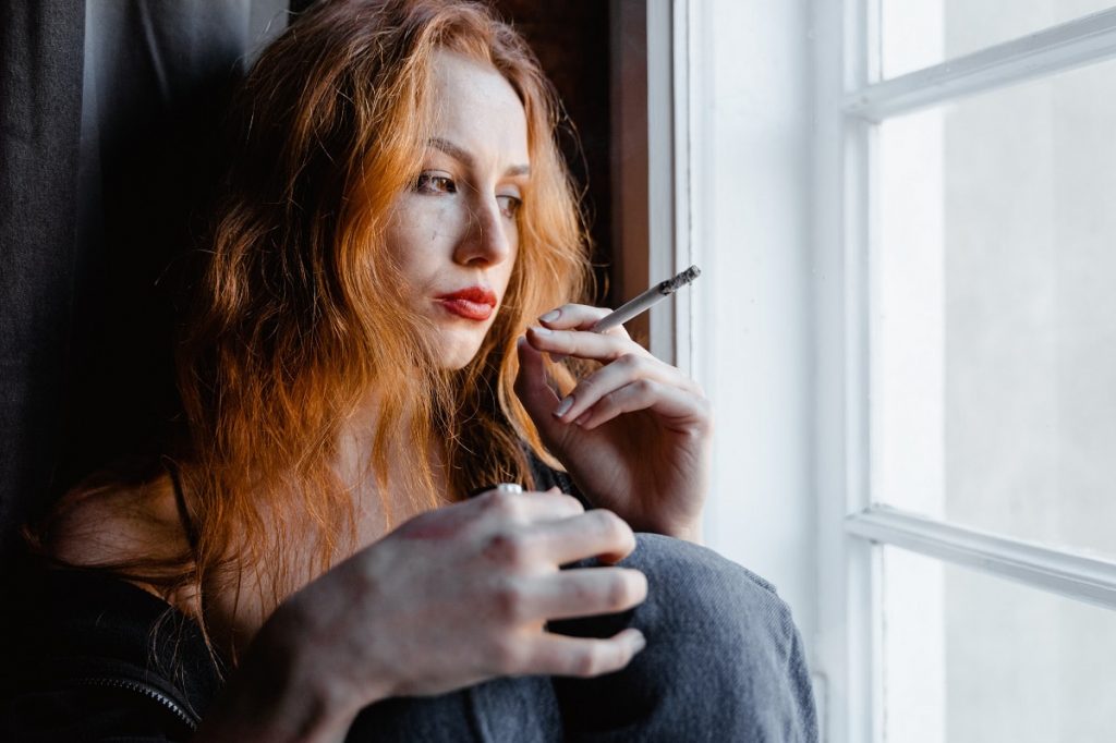 A young woman is smoking